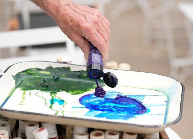 Kerry Awn helps restore the “Austintatious” mural he originally painted with Tom Bauman and Rick Turner as University of Texas art students in 1973, on the north wall of the University Co-Op Monday April 1, 2024.