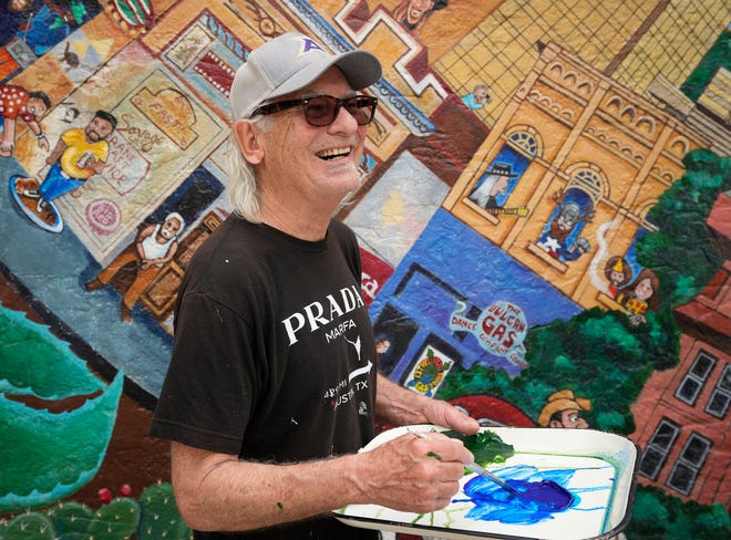 Kerry Awn helps restore the “Austintatious” mural he originally painted with Tom Bauman and Rick Turner as University of Texas art students in 1973, on the north wall of the University Co-Op Monday April 1, 2024.