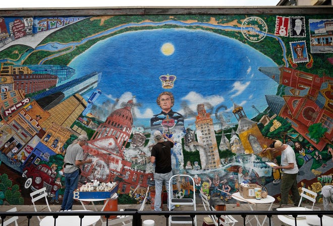 Tom Bauman, left to right, Kerry Awn and Rick Turner restore their “Austintatious” mural they originally painted as University of Texas art students in 1973, on the north wall of the University Co-Op Monday April 1, 2024.