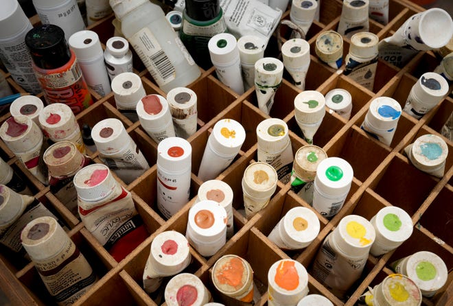Paint used by Tom Bauman, Kerry Awn, and Rick Turner to restore their “Austintatious” mural they originally painted as University of Texas art students in 1973, on the north wall of the University Co-Op Monday April 1, 2024.