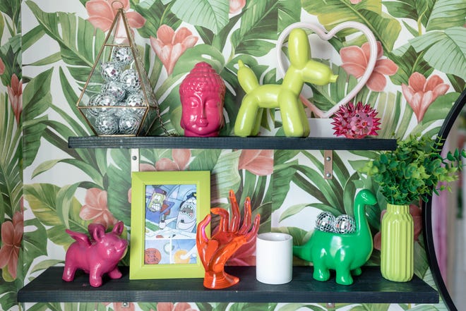 The bathroom shelves feature an assortment of items that have been painted to match the color scheme of the room at this home in Louisville's Fern Creek area.