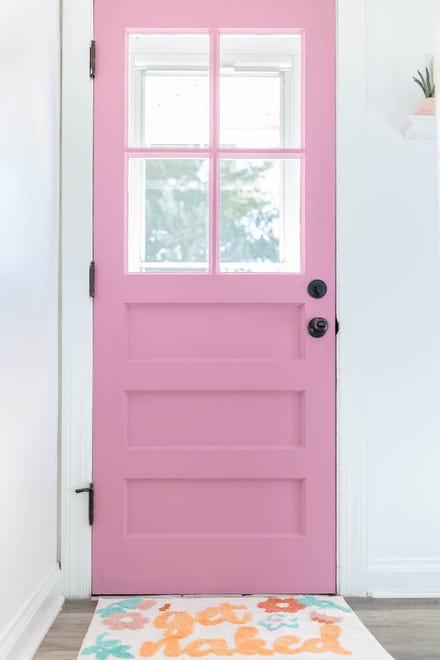 A fun welcome mat adds a bit of color to the space near the back door at this home in Louisville's Fern Creek area.