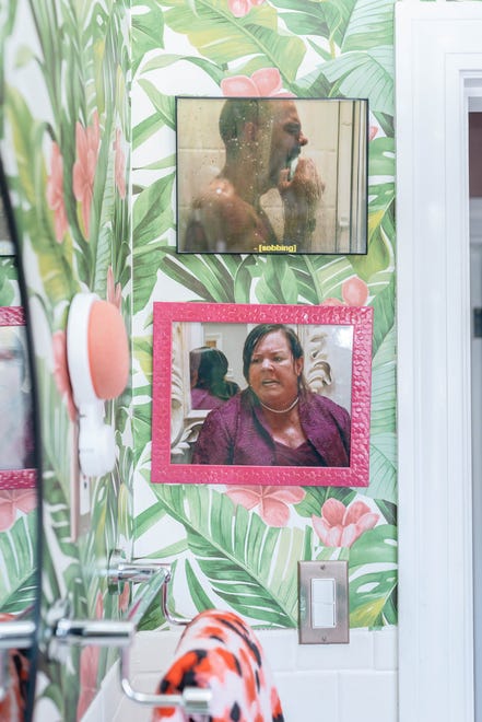 Bathroom scenes from various movies adorn the bathroom walls at this home in Louisville's Fern Creek area.