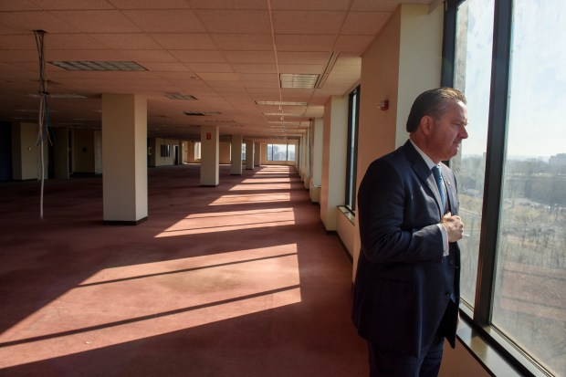 West Hartford real estate investor William H. Coons III looks out from the 10th floor of the 25 Sigourney Street tower.