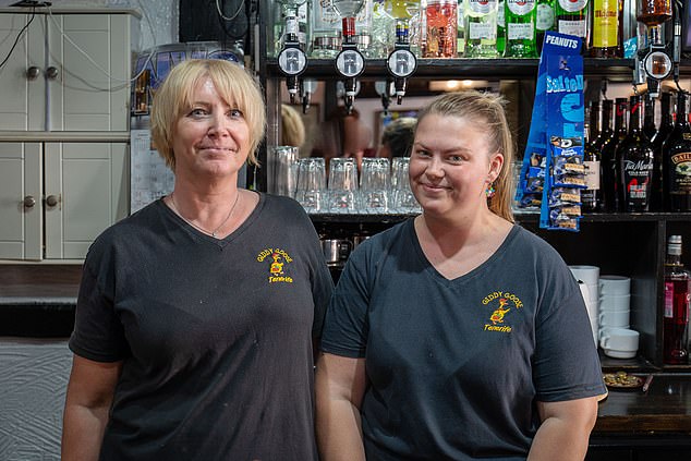 Melissa Taylor (left) and Terrilea Clayton (right) work in the popular Giddy Goose English pub in Las Playas de las Americas. Ms Taylor said: 'The anti-tourism stuff has suddenly peaked recently... without tourism there would be nothing here'
