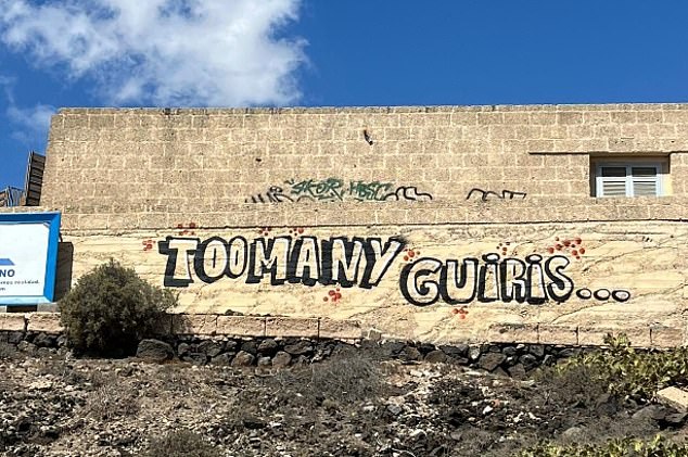 Slogans include 'too many guiris' , using a disparaging Spanish slang word for foreigners