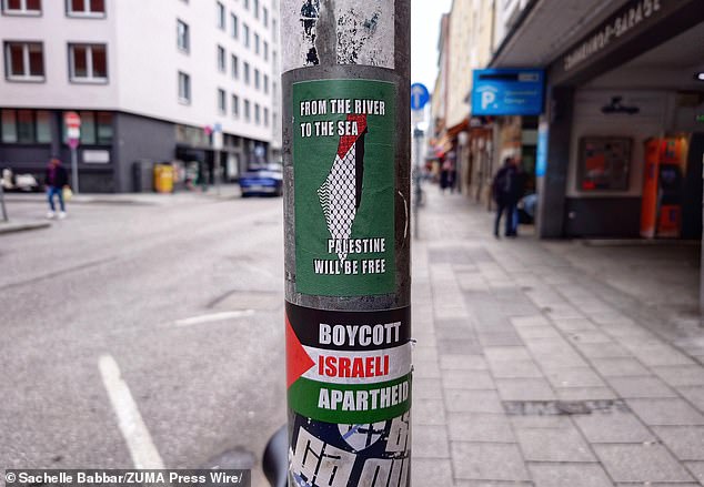 Stickers saying 'From the river to the sea Palestine will be free' and 'Boycott Israeli Apartheid' on a pole in Munich, Germany