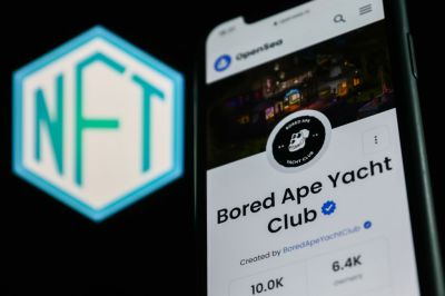 Bored Ape Yacht Club collection in OpenSea displayed on a phone screen and NFT logo displayed on a screen are seen in this illustration photo taken in Krakow, Poland on April 19, 2022. (Photo by Jakub Porzycki/NurPhoto via Getty Images)