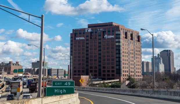 Traffic travels along I-84 in Hartford as graffiti covers the top of the 15-story office tower at 25 Sigourney St. in Hartford. (Aaron Flaum/Hartford Courant)