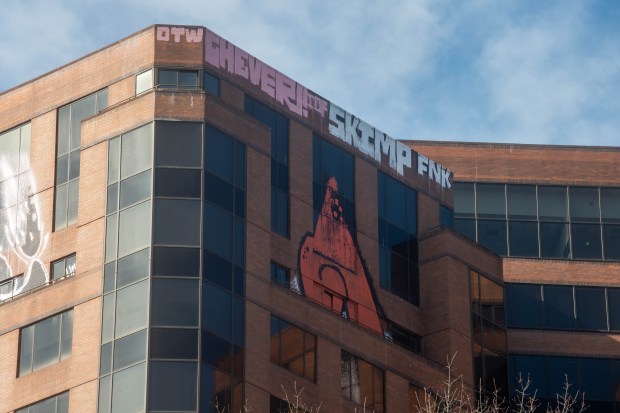 Graffiti covers the top of the former 15-story state office building at 25 Sigourney Street on Monday, March 18, 2024. (Aaron Flaum/Hartford Courant)