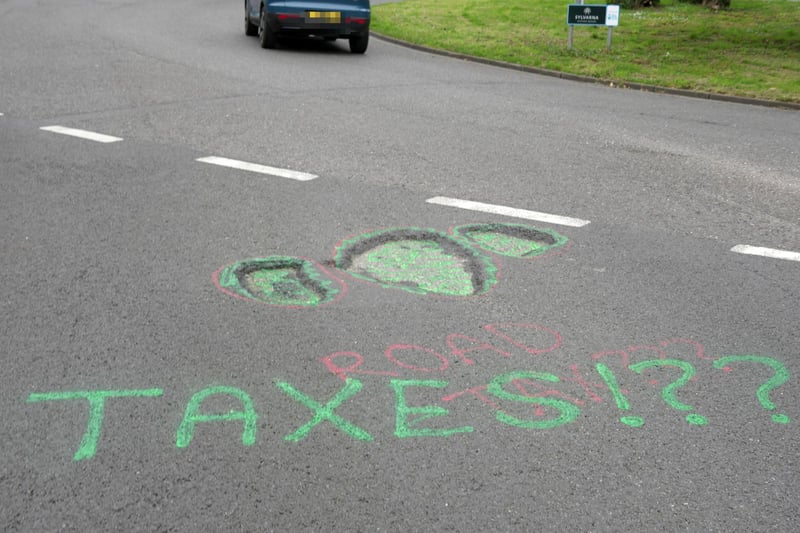 Graffiti seen in Chichester on Saturday, April 6, urging West Sussex County Council to fix several large potholes