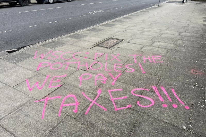 Graffiti seen in Chichester on Saturday, April 6, urging West Sussex County Council to fix several large potholes