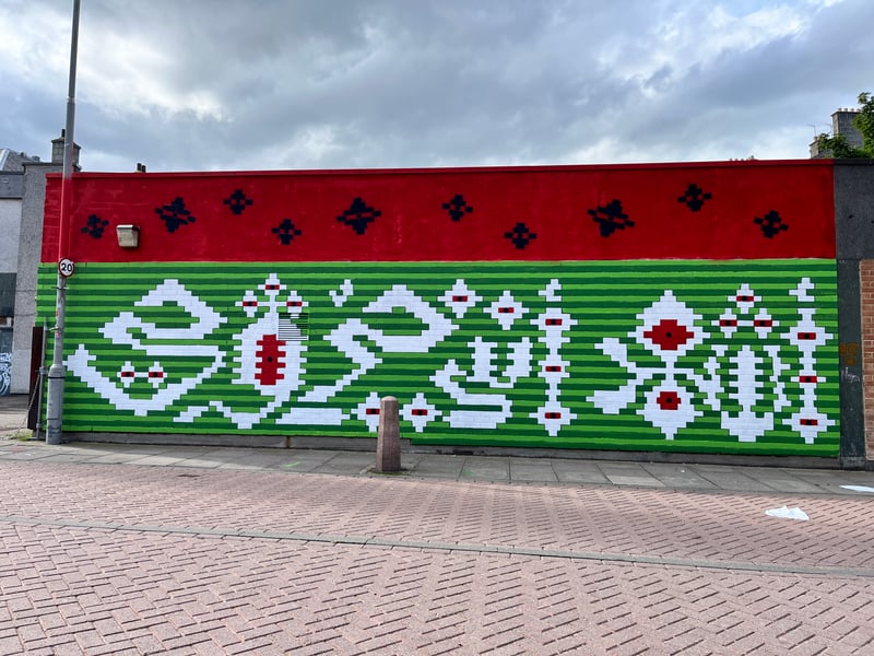 Professor Bahia Shehab worked with local community groups in the city ahead of installing her 2024 Nuart Aberdeen mural. The work directly interprets a Palestinian poem which translates to